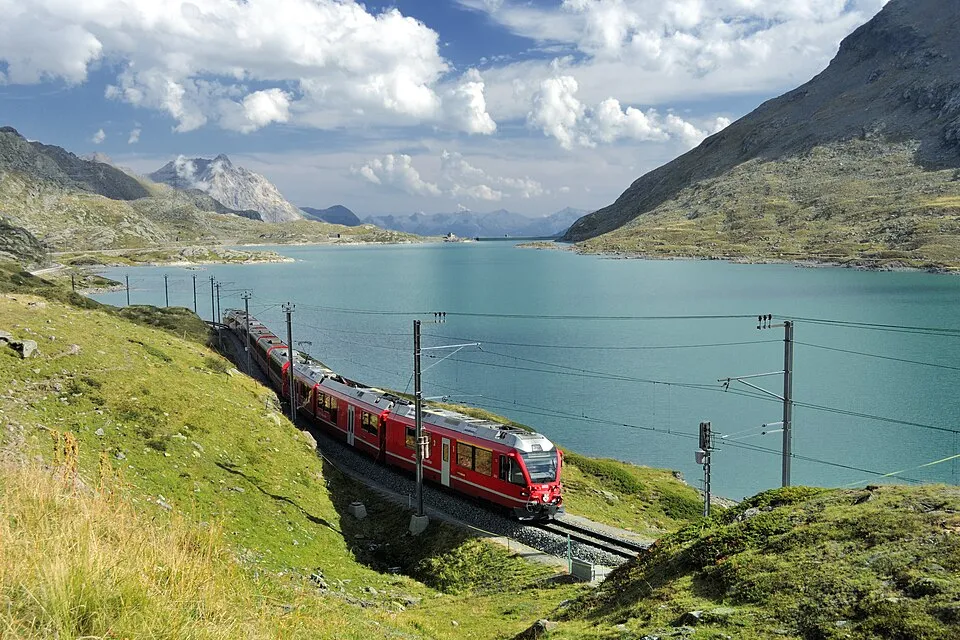 Bernina Railway passenger train crossing the Swiss Alps, representing European rail itineraries